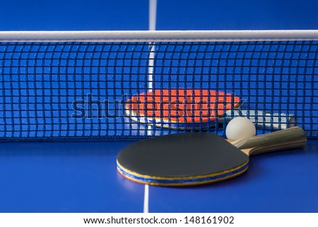 Table tennis rackets. Top view of table tennis rackets and ball lying on the tennis table