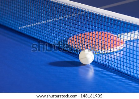 Table tennis racket. Top view of table tennis racket and ball lying on the tennis table