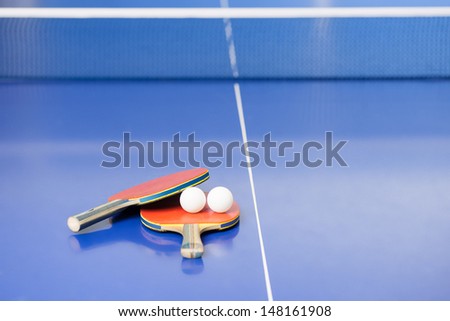 Table tennis rackets. Top view of table tennis rackets and balls lying on the tennis table