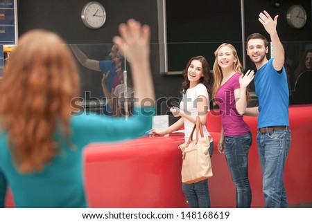 FriendÃ?Â¯Ã?Â¿Ã?Â½ meeting at the cinema. Cheerful young people greeting their friend at the cinema box office