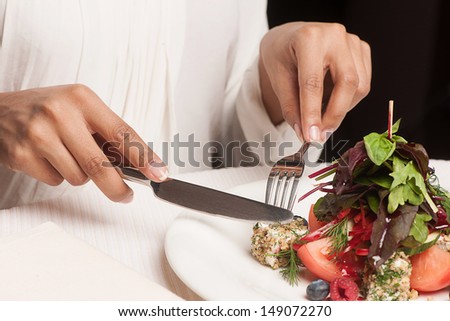 Woman at the restaurant. Cropped image of woman eating at the restaurant
