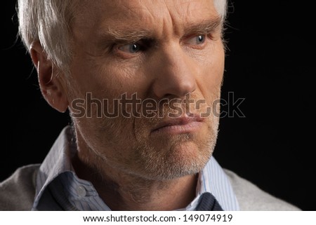 Senior man. Portrait of tired senior man isolated on black