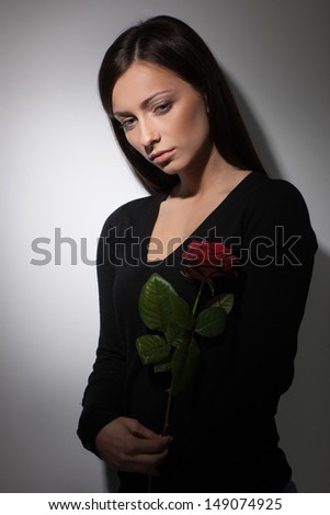 Sad women. Young depressed women holding a rose and looking away