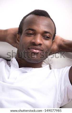 Men relaxing. Relaxed African descent men holding his head in hands and looking away