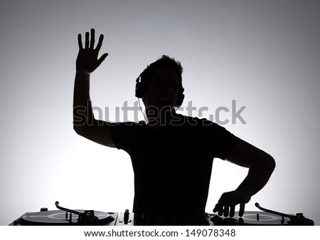 Dj Silhouette. Silhouette Of Dj Gesturing And Spinning On Turntable
