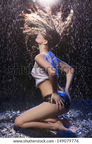 Wet beauty. Beautiful wet women posing under the rain