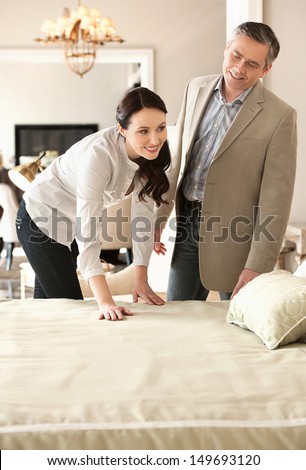 Couple In Furniture Store. Cheerful Middle-Aged Couple Choosing Furniture In Store