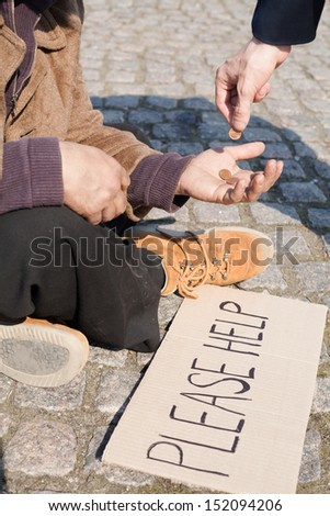Tramp. Close-up of man giving money to tramp