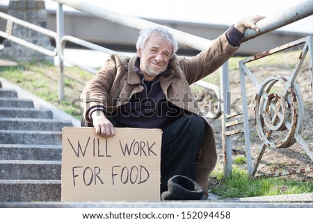 Will work for food. Depressed man in dirty wear holding poster while sitting on stairs