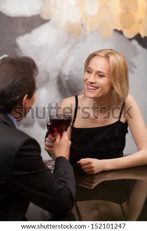Mature couple at the restaurant. Beautiful middle aged couple drinking red wine at the restaurant