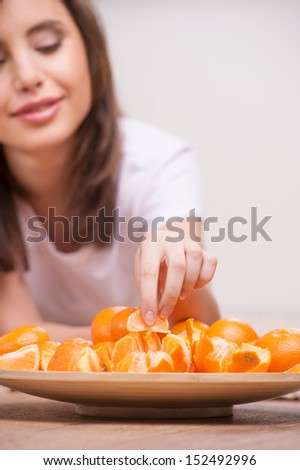 Woman eating oranges. Close-up of woman eating oranges and smiling