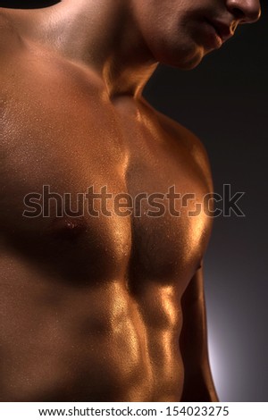 Muscular man. Close-up of muscular man standing isolated on white