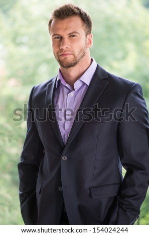 Confident businessman. Handsome young man in formalwear looking away