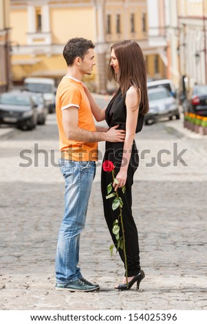 Loving couple. Full length of beautiful young loving couple hugging and looking at each other