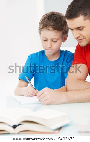 Father and son. Father helping his son with homework