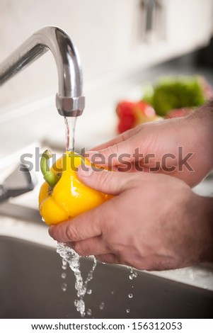 Washing vegetables. Close-up of chef washing fresh vegetables