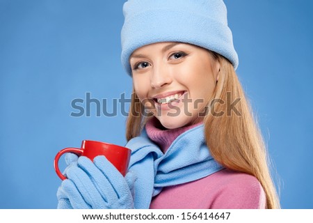 Beautiful woman. Beautiful young woman in winter wear looking at camera and holding cup