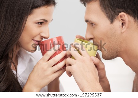 Loving couple. Beautiful loving couple looking at each other and drinking coffee