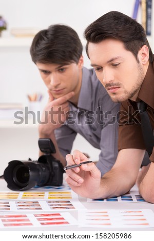 Two men choosing the right photo from the shoot. Close up shoot