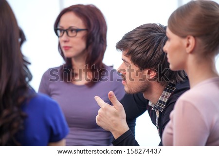 Close Up Of Group Of People. Discussing Something Interesting In A Circle