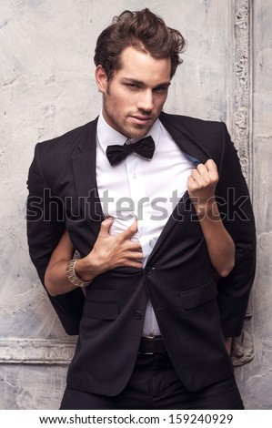 Sexy Handsome Nab In Classical Costume. Female Hands Unbutton His Coat And Shirt