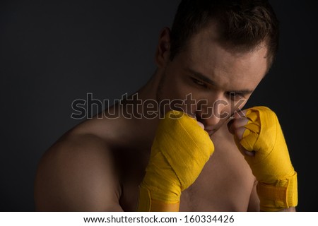 Close up of handsome young sportsman. Training martial arts, looking away