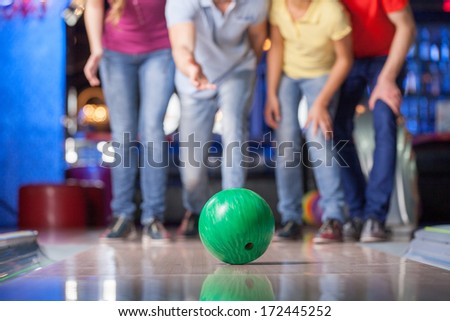 Group of friends bowling. Happy group of friends having fun bowling