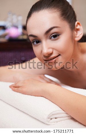 girl laying on massage table. girl is given massage of her back
