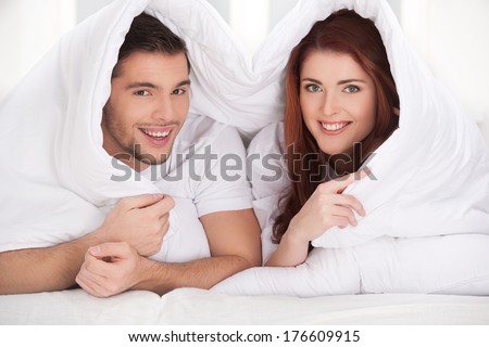Young Couple Lying Together In Bed. Newly Wed Woke Up In Morning