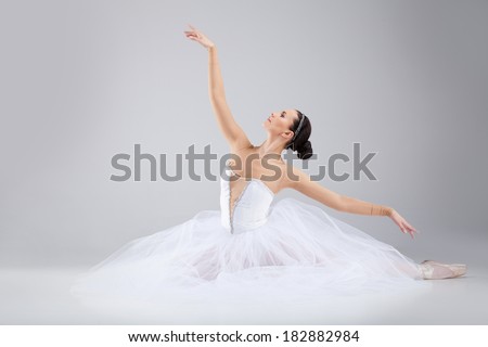 attractive young ballet dancer acting out. beautiful ballerina sitting forward split