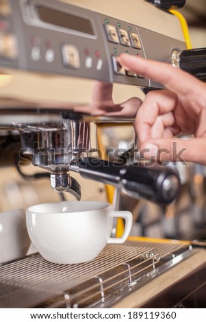 Making coffee. Waitress operating espresso machine coffee house