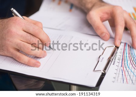 Writing documents. Details of working.Close-up of businesswoman\'s hands.