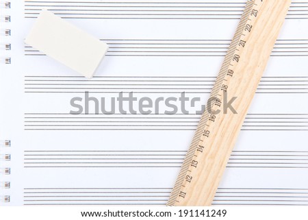 Back to school. Eraser, ruler and notebook on white background