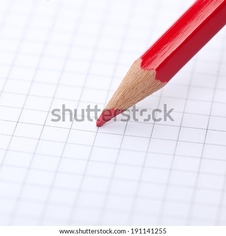 Pencil and blank notebook. Red pencil about to write in blank note book.