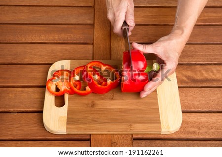 Cooking Red Bell Pepper. Man Cutting Red Bell Pepper on Cutting board