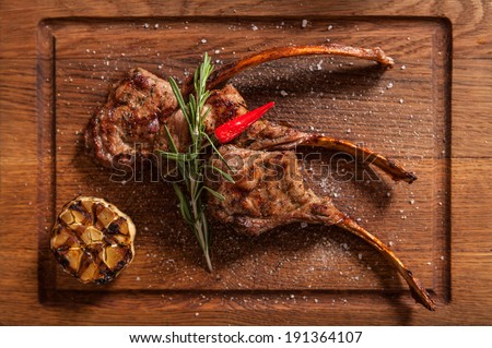 Braised Lamb Chops. Top view of Rack of Lamb with Garlic, Rosemary and Peppercorns