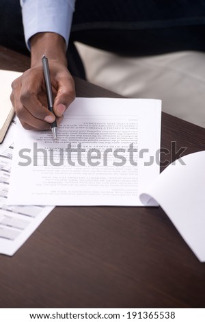Businessman Signing a Document. Businessman filling in an application form