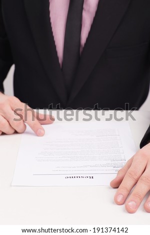 Job Interview. Someone looking over a submitted resume, or a person editing their own resume