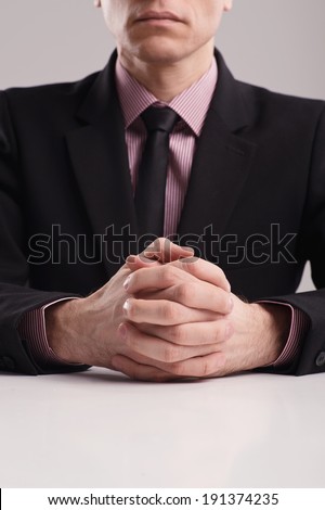 Business Body language. Businessman\'s hands at the white meeting table.