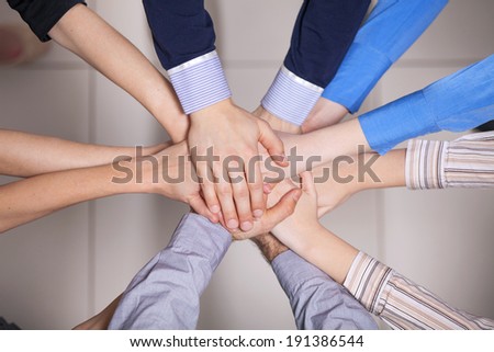 Hands in. Closeup of pile of hands of a business team showing unity