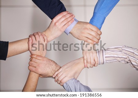 People showing unity. Men and women holding hands of each other