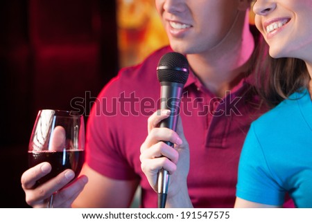 Karaoke at a Party. Attractive people on a karaoke party in discotheque