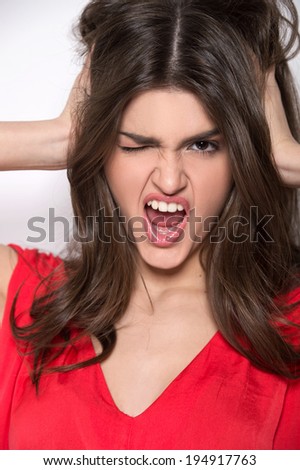beautiful young girl showing emotions. attractive lady shouts and holding head