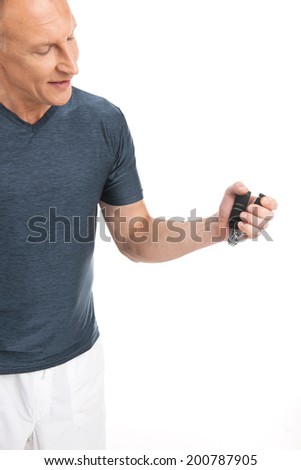 Hand holding gripper on white background. aged man squeezing and training hands