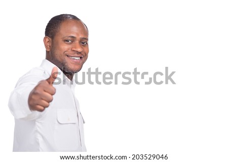 handsome black man shows thumbs up. person standing on white background smiling