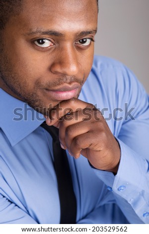 good looking black man thinking. handsome man folded hands and thinking