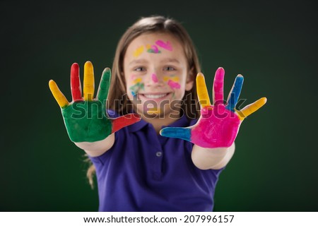 cute little girl showing hands. small girl with colorful hands and fingers