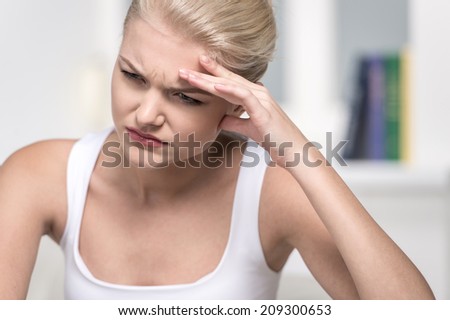 Close up Portrait of woman with headache. Teen woman holding her hand to head