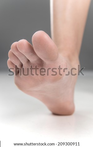 Women beautiful Foot stepping closeup. feet walking on floor with fingers closeup