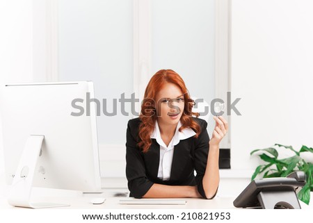young designer woman having idea. young woman holding electric lamp in her hand in office